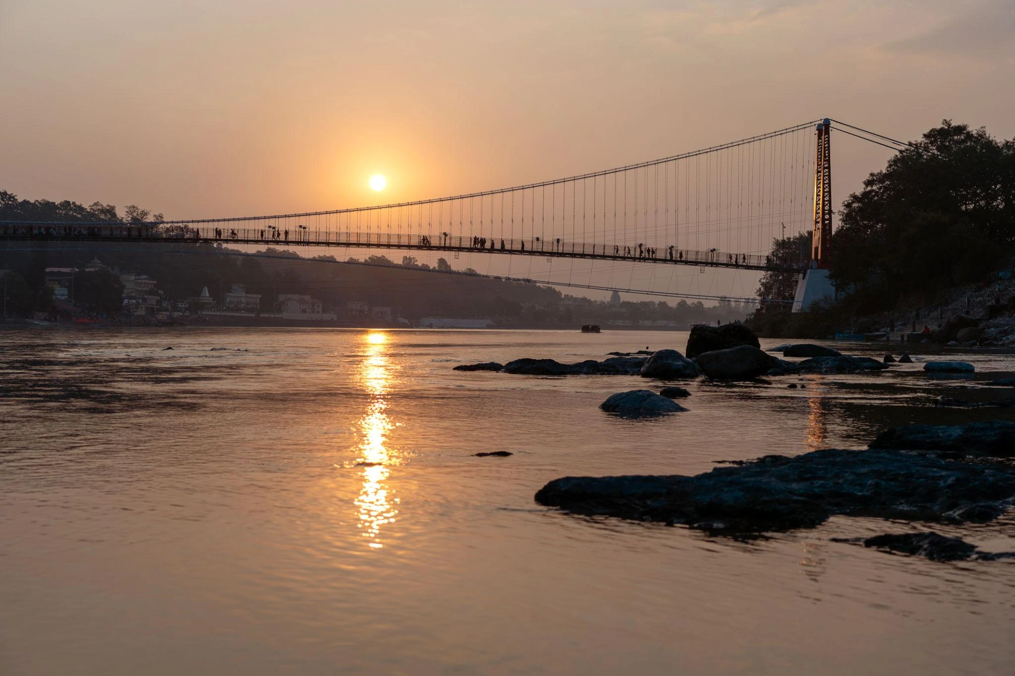 Ganges river embankment and bridge at sunset in Teendham Yatra Package (Kedarnath, Badrinath, Gangotri) tour package gallery image 4