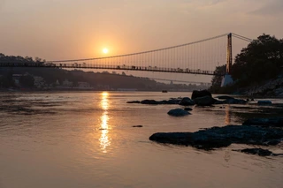Ganges river embankment and bridge at sunset thumbnail for Teendham Yatra Package (Kedarnath, Badrinath, Gangotri) 4